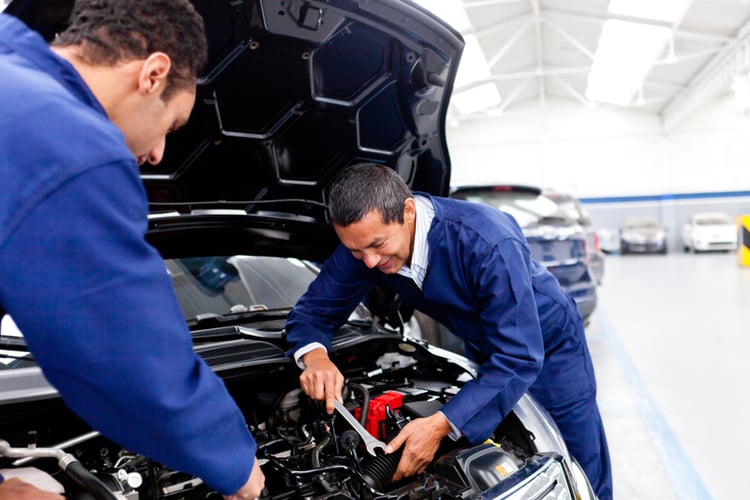 Male mechanics at the garage fixing a car-1